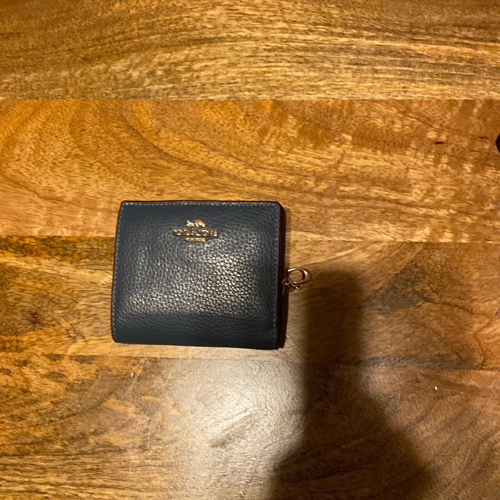 Beautiful Coach wallet with gold color details!